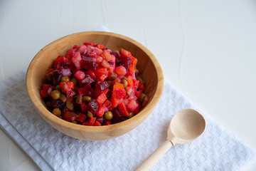 traditional russian salad vinaigrette on wooden bowl