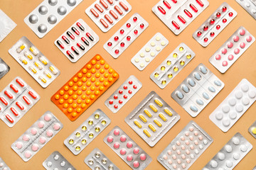 Different pills on color background