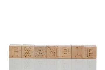 Wooden cubes with letters Example on a white background