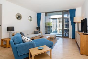 Interior design in villa, house, home, condo and apartment feature living room with television, middle table, cushion and open space kitchen and dining room