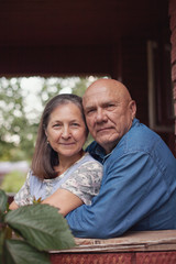 Obraz premium pensioners on porch of house in village.