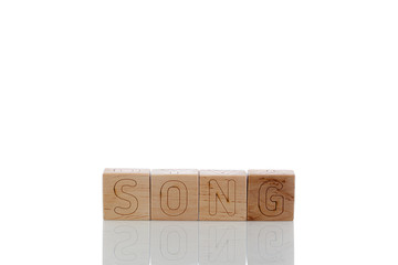 Wooden cubes with letters song on a white background