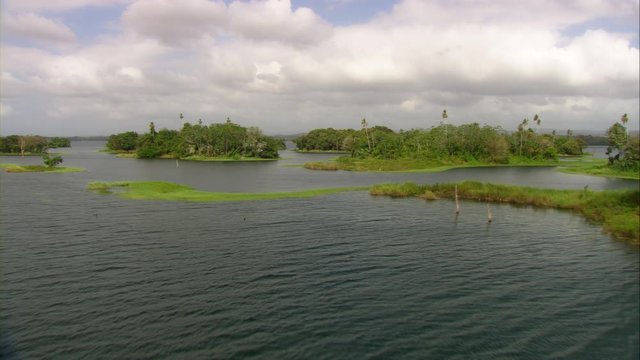Aerial view of Lake Bayano, small islands with palms and cloud forest in Panama Central America, filmed with Cineflex stabilization camera system