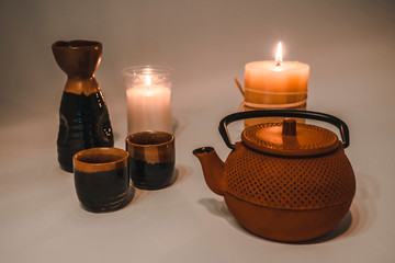 Japanese tea with beautiful candlelight and a Japanese cup and glasses
