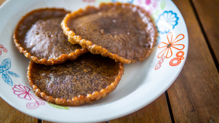 Close up view of Cucur Jawa or Cucur Topi, a traditional Malay food in a white plate.