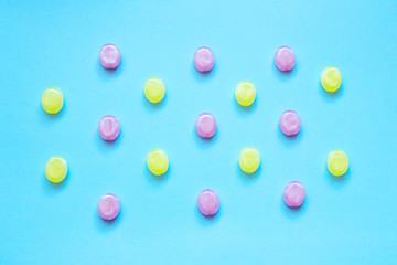 Multicolored candys on a colored background