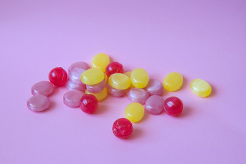 Multicolored candys on a colored background
