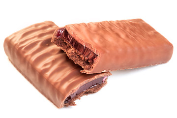 Sweet chocolate bar with cherry jelly filling. Brownie chocolate coated snack dessert. Two halves closeup.