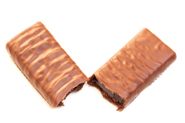 Two halves of brownie chocolate coated bar. Sweet snack food cake with fruit jelly filling inside. 
