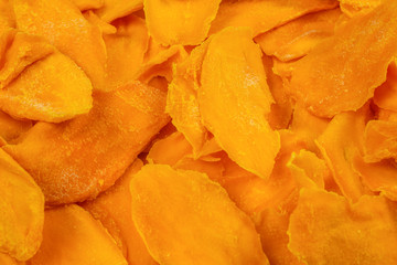 Tasty sugar mango slices background. Top view.