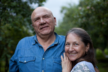 Portrait of   elderly couple   on   summer day.