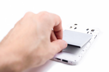 The process of replacing the battery in a cell phone.