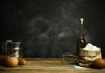 Cooking and baking background. Old kitchen with products and ingredients (flour, butter, eggs) for dough and baking bread, pasta and pizza
