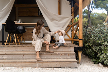 mother with baby sitting on the bench