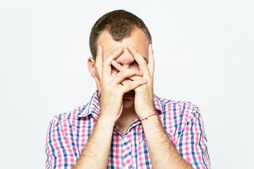 Man covering his face