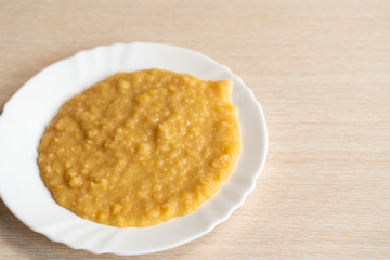 Yellow pea puree in a white plate