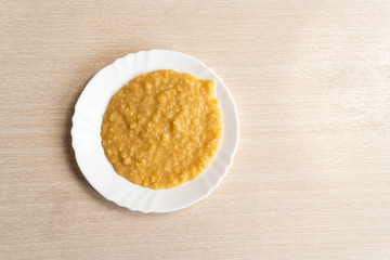 Yellow pea puree in a white plate