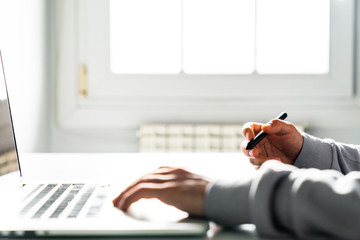 Young man designer using graphic tablet while working with computer.