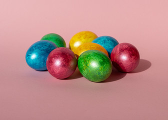 Colorful easter eggs on pink background. Happy Easter composition. Copy space.
