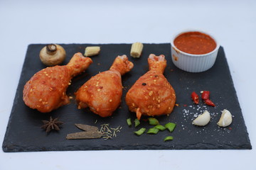 whole chicken merinated drumstick and boneless with sauce and spices on table