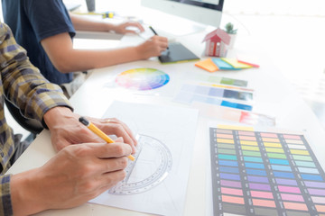 Engineers and creative artists work on table, work, consult, advise on choosing colors and materials, measuring size, choosing cool colors, soft tones, beautiful tones.