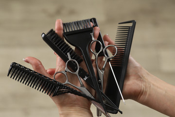 Barber tools: scissors,comb, paint brush in the hands of the master
