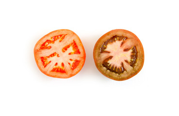 Comparison of a slice of tomatoes of different varieties. Two sliced red and green tomato halves on...