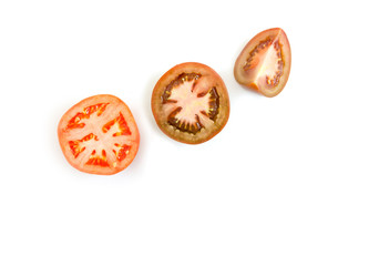 Sliced tomatoes halves and quarters on a white background. Place for text.