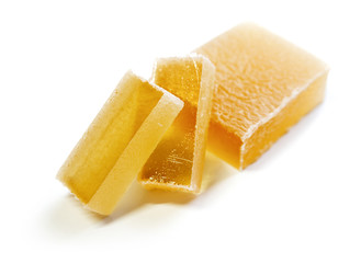 Pieces of yellow marmalade on white background