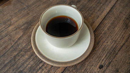 black coffee on wooden table. ceramic round cup. background,