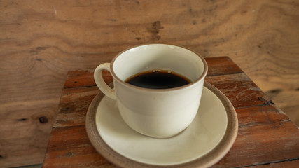 black coffee on wooden table. ceramic round cup. background