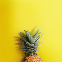 Fototapeta na wymiar Pinapple on pastel yellow background. Exotic fruits background.