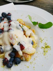 Kaiserschmarrn Austrian dessert traditional dish with scrambled pancakes and fruits