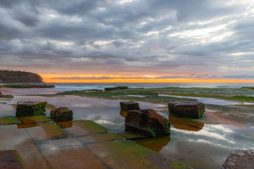 Rocky platform at Turimetta Beach, Sydney, during low tide in the morning.