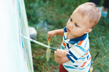 boy painting with brush