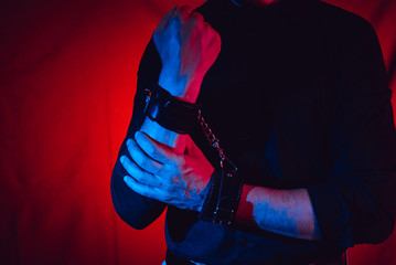 men's hands chained in leather handcuffs for BDSM sex . submission and domination