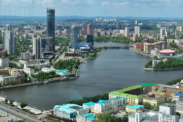 Fototapeta premium Yekaterinburg, the capital of the Urals, aerial view. Many beautiful residential and commercial buildings, as well as the architectural ensemble of the city, under the summer sun, top view.