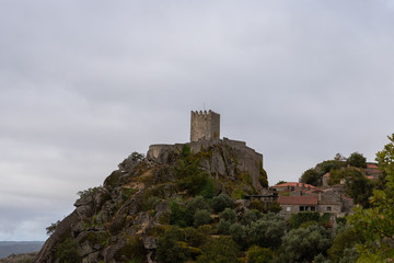 Fototapeta na wymiar Sortelha medieval castle on a very cloudy day. Sortelha is one of historic villages of Portugal, located in Guarda district