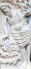 Ancient aged sculpture of a saint Biblical personage, bearded elder man at Doge Palace facade in Venice, Italy