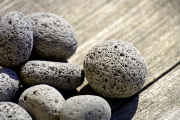 close-up of gray porous lava pebbles background, round lave stones as garden decoration