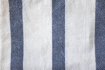 White linen towel background with blue stripe, top view