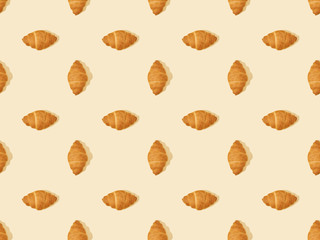 top view of delicious fresh croissants on beige, seamless background pattern