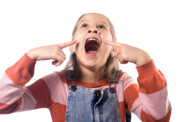 Little cute girl shows her orthodontic appliance on a white background