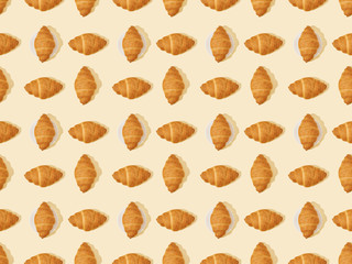 top view of fresh croissants on beige, seamless background pattern