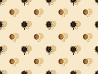 Fototapeta na wymiar top view of cups of fresh coffee on beige, seamless background pattern