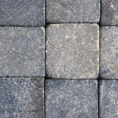 Stone background close-up. Natural texture. Light gray bluish backdrop or wallpaper. Rough surface. Reduced contrast. Square shot. Macro