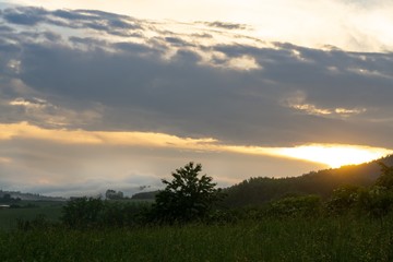 Naklejka na ściany i meble Sunrise or sunset over the hills and meadow. Slovakia