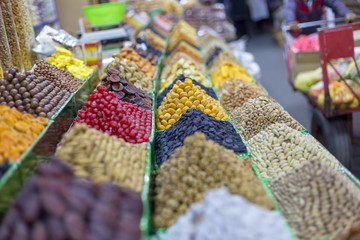 Market stall with various dried fruits and nuts