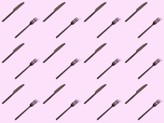 top view of black knives and forks, seamless background pattern