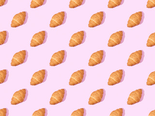top view of croissants on pink, seamless background pattern